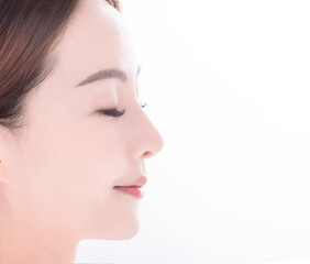 side view of  young asian woman with clean fresh skin on white background