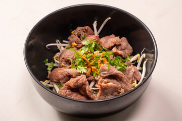 Instant - Boiled Beef dip with hot in white dish and sour sauce in Thai food style on top view, scald thin slices of beef in boiling water; instant-boil in Thai food style