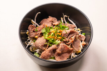 Instant - Boiled Beef dip with hot in white dish and sour sauce in Thai food style on top view, scald thin slices of beef in boiling water; instant-boil in Thai food style