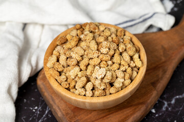Dried mulberry. Sun-dried organic white dried mulberry in wooden bowl. Superfood, Vegetarian food concept. healthy snacks. Close up