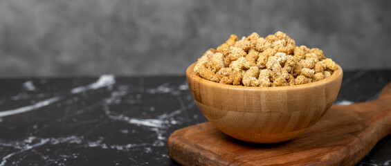 Dried mulberry Sun-dried organic white dried mulberry in wooden bowl. Superfood, Vegetarian food concept. healthy snacks. Copy space. Empty space for text