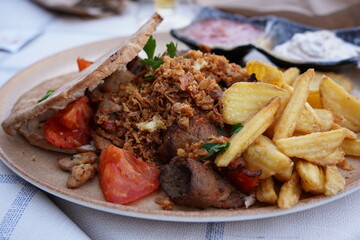 Traditional greek, turkish meat food on pita bread and tzatziki. Gyros pita