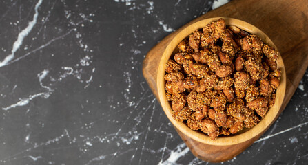 Honey with sesame peanuts. Sesame peanuts in wooden bowl. Superfood, Vegetarian food concept. healthy snacks. Copy space. Empty space for text