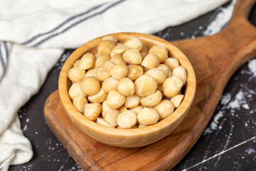 Macadamia Nuts. Macadamia Nuts in wooden bowl. Superfood. Vegetarian food concept. healthy snacks. Close up