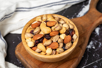 Mixed nuts. Special mixed nuts in wooden bowl. Hazelnut, almond, cashew, pistachio, dried blueberry. Superfood. Vegetarian food concept. healthy snacks. Close up
