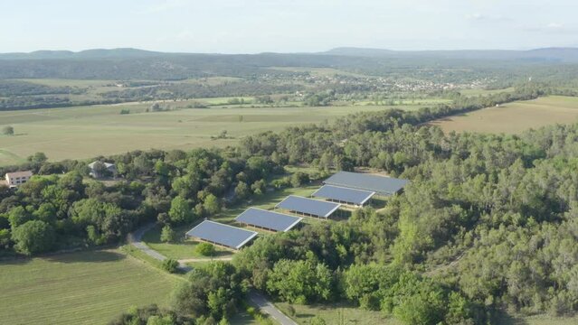Aerial shot of photovoltaic panels in the heart of a forest in the French countryside