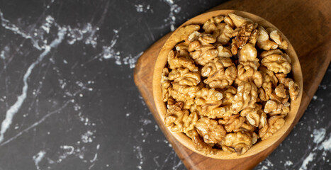 Walnut. Walnut kernel in wooden bowl. Superfood. Vegetarian food concept. Healthy snacks. Copy space. Empty space for text