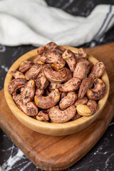 Cashew nuts . Roasted cashew nuts with shell in wooden bowl. Superfood. Vegetarian food concept. Healthy snacks. Close up