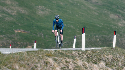 Uo man pedals on his bike uphill
