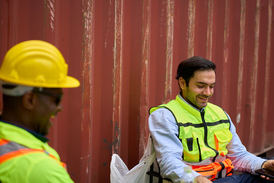 Relax scene with engineer and foreman after working in container box site.