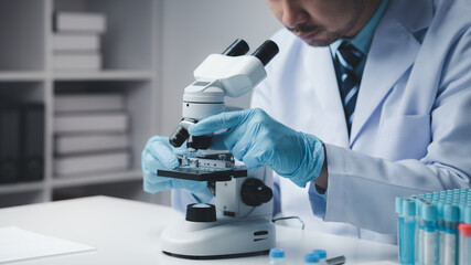 Lab assistant, medical scientist, chemistry researcher holds a glass tube through a chemical test tube, does a chemical experiment and examines a patient's sample. Medicine and research concept.