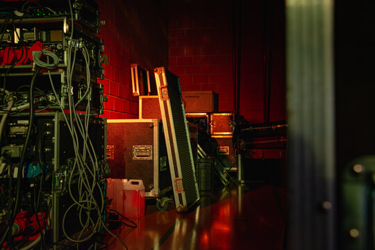 Experience the electrifying anticipation of live music with this stock image. Warm, moody lighting showcases concert equipment and cases