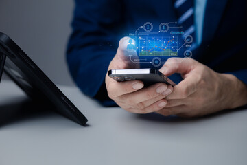 Businessman holding smartphone with business hologram, using technology to analyze and plan business, marketing, planning solutions in business using modern technology.