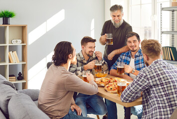 Happy men friends eating pizza and drinking beer. Cheerful hipster guys in casual clothes sitting at table, eating, talking to each other and having fun. Meeting of best friends, food and leisure