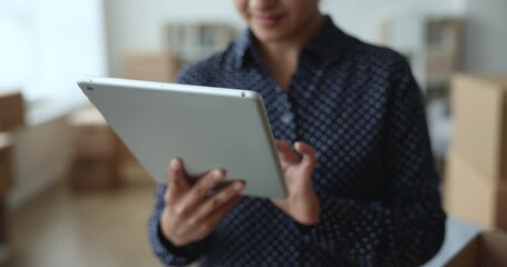 Close up view female hands holds tablet, retail electronic commerce services client, make order online, via website, buy goods for new house. Small business owner check orders working from warehouse