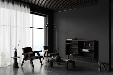 Black living room interior with armchairs and sideboard near panoramic window