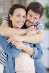 a happy couple hugging indoors