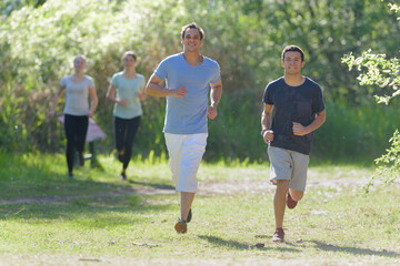 group of people jogging on a summers day