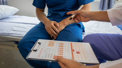 Professional therapist stretching Patients with muscular disease, rehabilitation and treatment of...