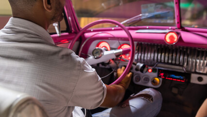 On board an old American car in the streets of Havana in Cuba