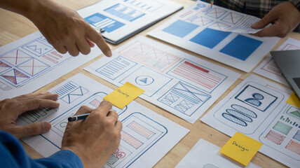 Close-up ux developers and ui designers use augmented reality to brainstorm on mobile app interface...