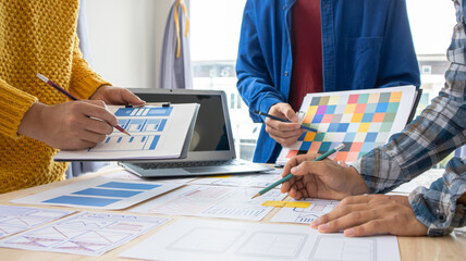 Close-up ux developers and ui designers use augmented reality to brainstorm on mobile app interface...
