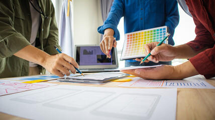 Close-up ux developers and ui designers use augmented reality to brainstorm on mobile app interface...