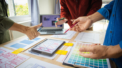 Close-up ux developers and ui designers use augmented reality to brainstorm on mobile app interface...