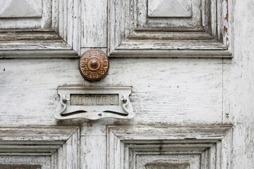 Beautiful old timber door with ornate metal doorknobs