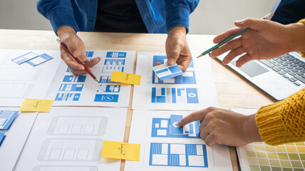 Close-up ux developers and ui designers use augmented reality to brainstorm on mobile app interface...