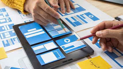 Close-up ux developers and ui designers use augmented reality to brainstorm on mobile app interface...
