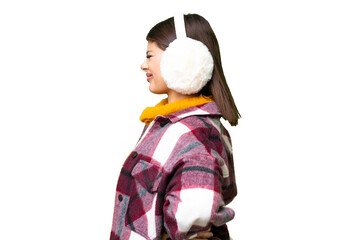 Young Russian woman wearing winter muffs over isolated chroma key background suffering from...