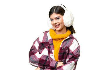 Young Russian woman wearing winter muffs over isolated chroma key background with arms crossed and looking forward