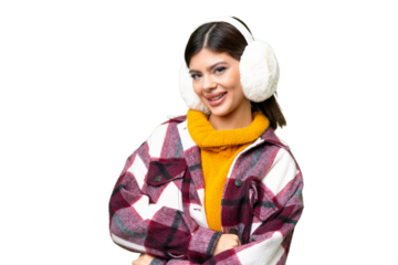 Young Russian woman wearing winter muffs over isolated chroma key background with arms crossed and looking forward