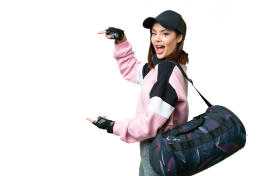 Young sport woman with sport bag over isolated chroma key background surprised and pointing side