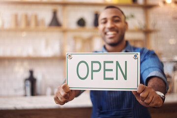 Closeup of open sign, man and owner of shop, store and advertising notice of retail trading time, services and information. Hands of happy cafe worker with opening banner, welcome and startup poster