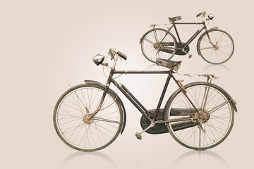Fototapeta na wymiar side view old and rust black and silver bicycles on gradient brown background, object, decor, transport, copy space