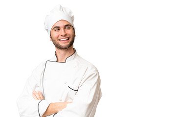 Young handsome chef man over isolated background with arms crossed and happy