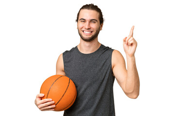 Young basketball player man over isolated background showing and lifting a finger in sign of the best