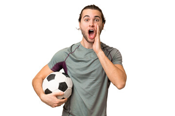 Young handsome football player man over isolated background with surprise and shocked facial expression