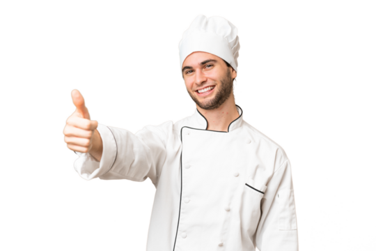 Young handsome chef man over isolated background giving a thumbs up gesture