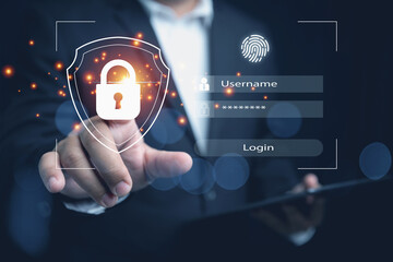 Businessman touching on a padlock with a shield for login privacy security and protection against identity theft access. Virtual screen with a padlock on a shield, login, username, and password.