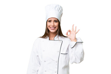 Young chef caucasian woman over isolated background showing ok sign with fingers