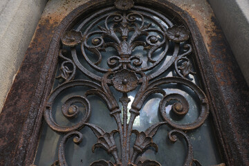 Rust deteriorations. Really old and decrepit door from a century-old cemetery (Père Lachaise, France)