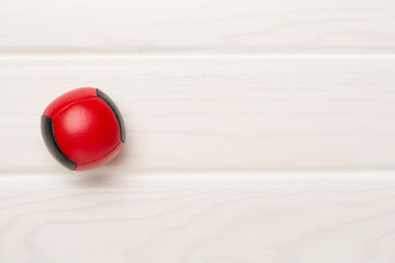 Colorful juggling ball on wooden background, top view