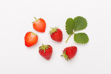 Strawberries with leaves on white background, top view