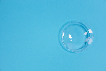 Fototapeta na wymiar glass bowl on blue background