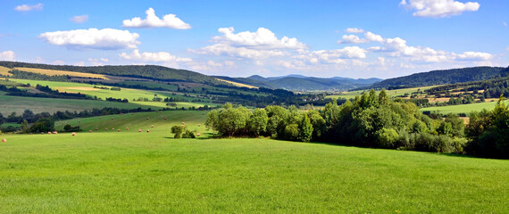 Panoramic view of Low Beskids (Beskid Niski) mountain range from the nearby slopes. Low Beskids is part of Carpathian mountains in Poland. - obrazy, fototapety, plakaty