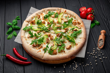 Delicious pizza with grilled chicken, avocado, and arugula.