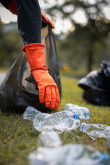 Man picking up plastic waste to clean up at a park